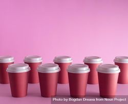 Disposable coffee cups on pink background bGMzB5