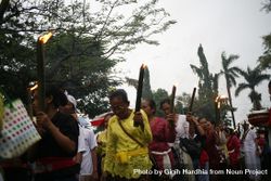 Group of mature Indonesian Hindu women with torches marching during Nyepi day bxoAB4