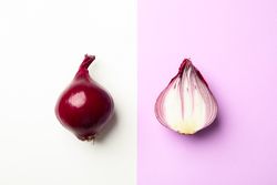 Flat lay composition with red onion on two tone background