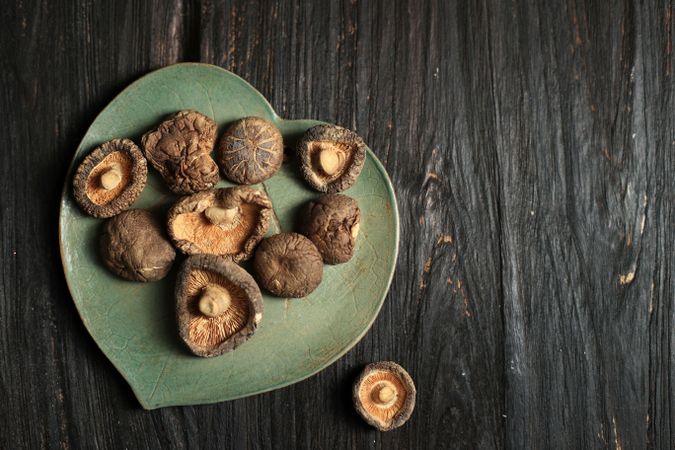 Dried shitake mushrooms on heart shaped plate