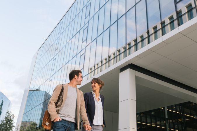 Businesspeople couple outside contemporary building