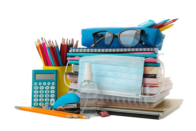 School supplies with medical mask and sanitizer isolated on neutral background