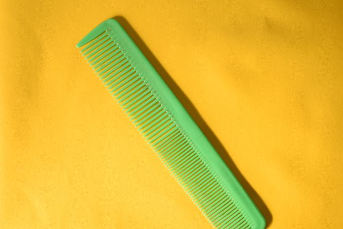 Green comb in yellow studio