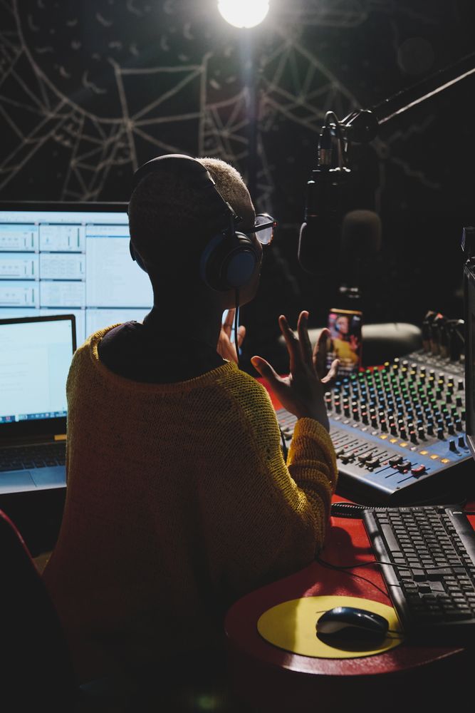 Unrecognizable Black woman in dark broadcast studio
