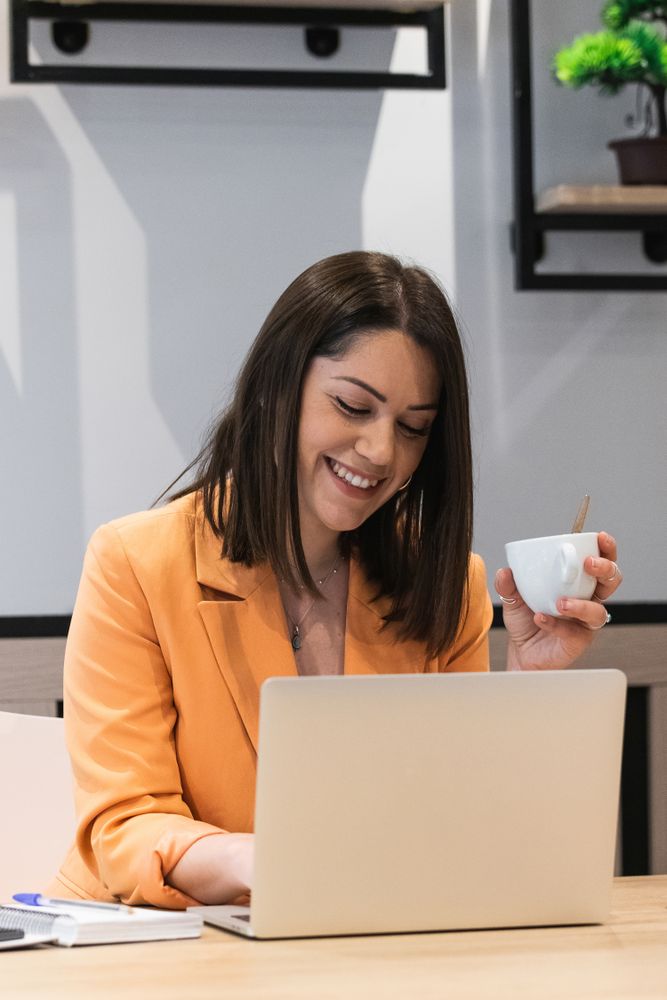 Optimistic woman working on laptop in cafe