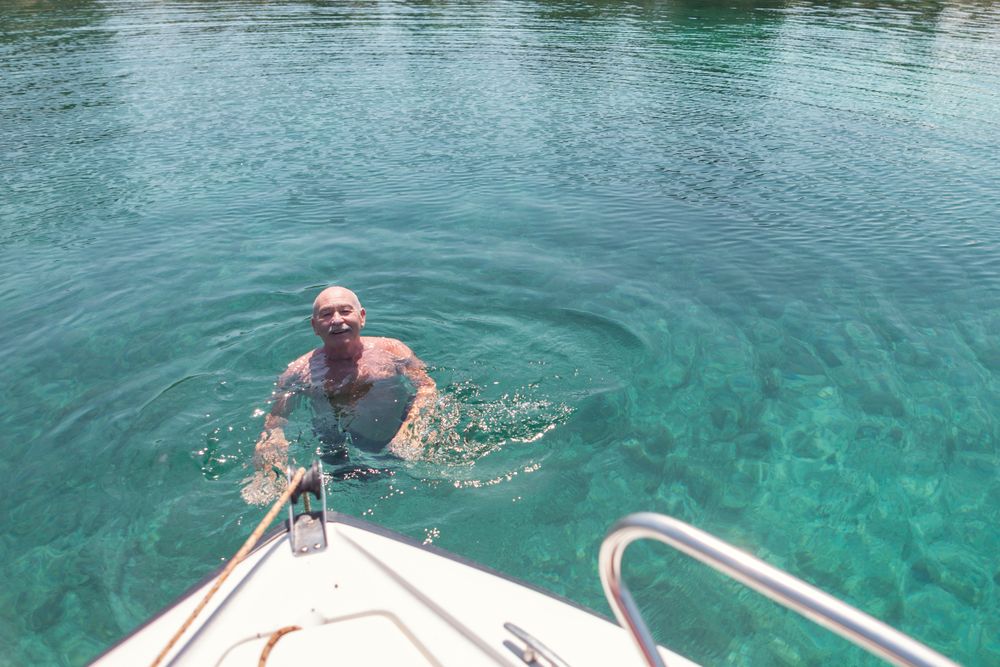 Man swimming in clear turquoise water