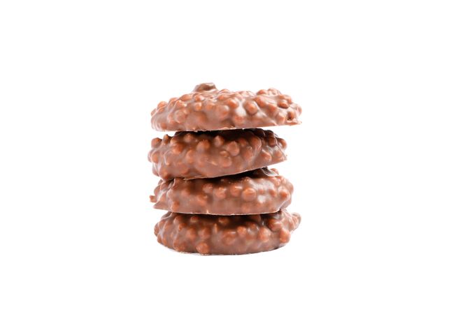 Stack of chocolate cookies with caramel filling isolated on blank background