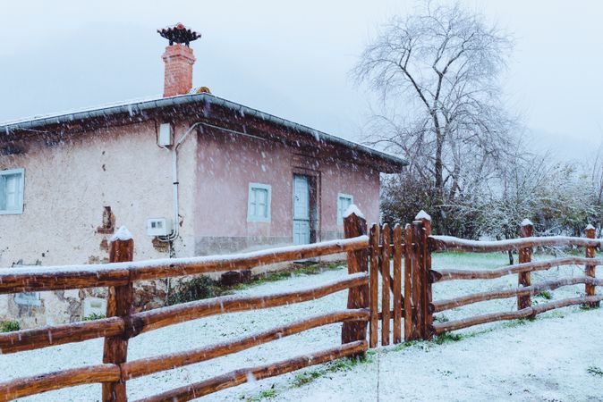 Old building and wooden fence in winter