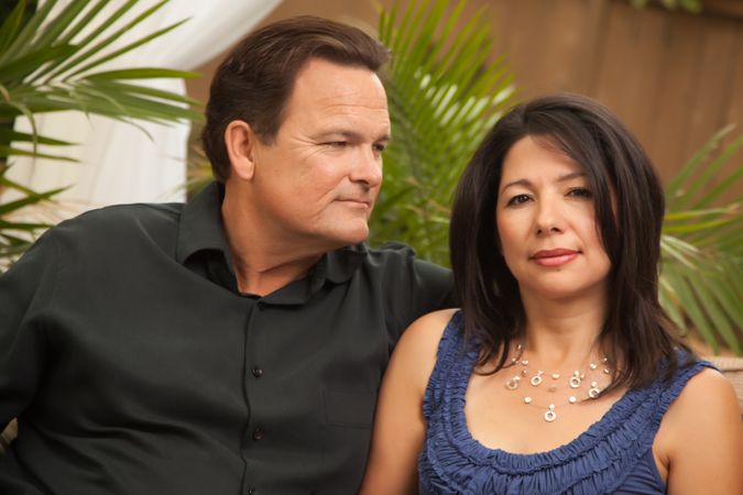 Calm Couple Sitting In Front of Fern