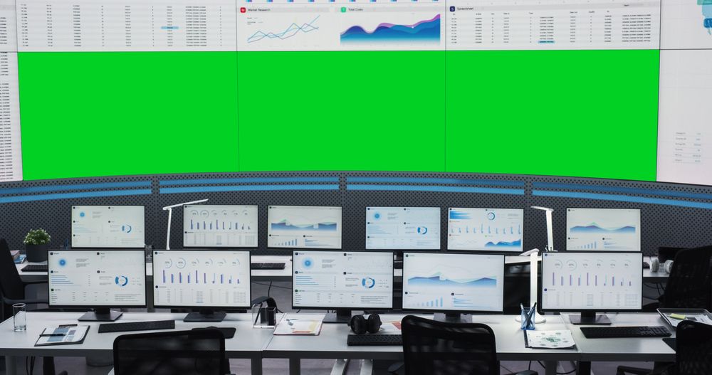 Empty Monitoring Office With Green Screen Chromakey On Big Digital Screen.