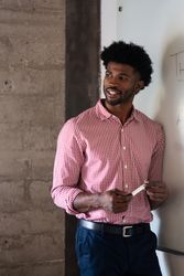 Man holding marker standing at a dry erase board