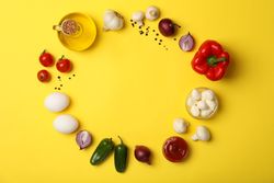 Ingredients for cooking on yellow background, top view