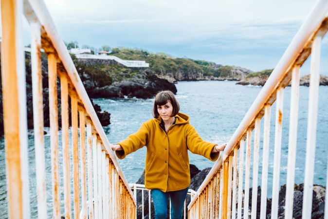 Woman standing on steps near sea