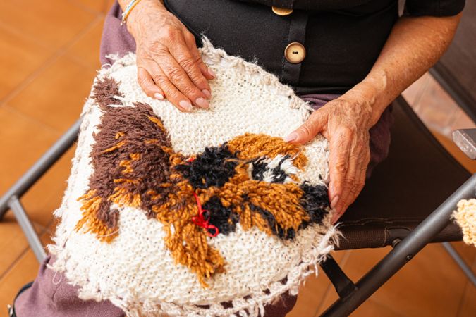 Mature woman knits with love.