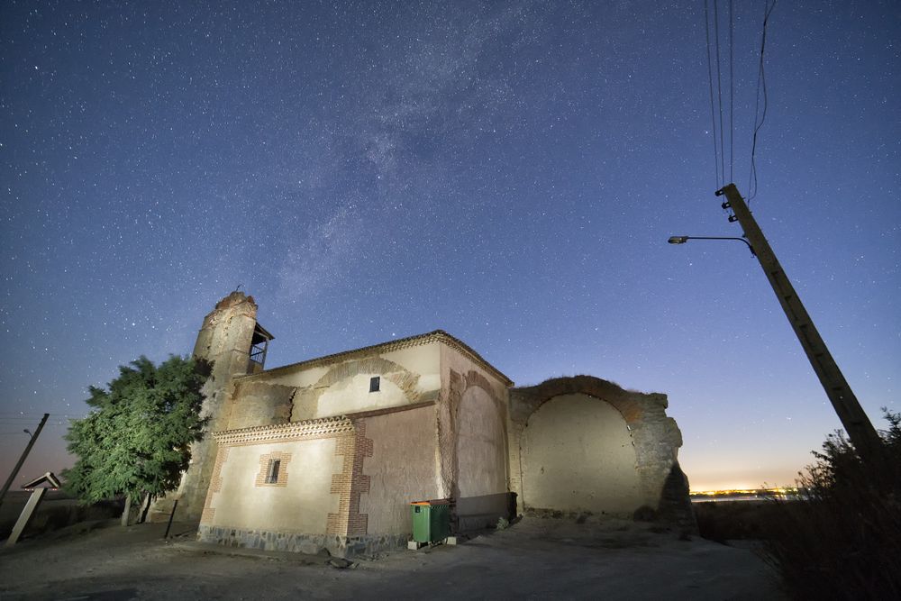 Aged cathedral in suburbs under starry sky