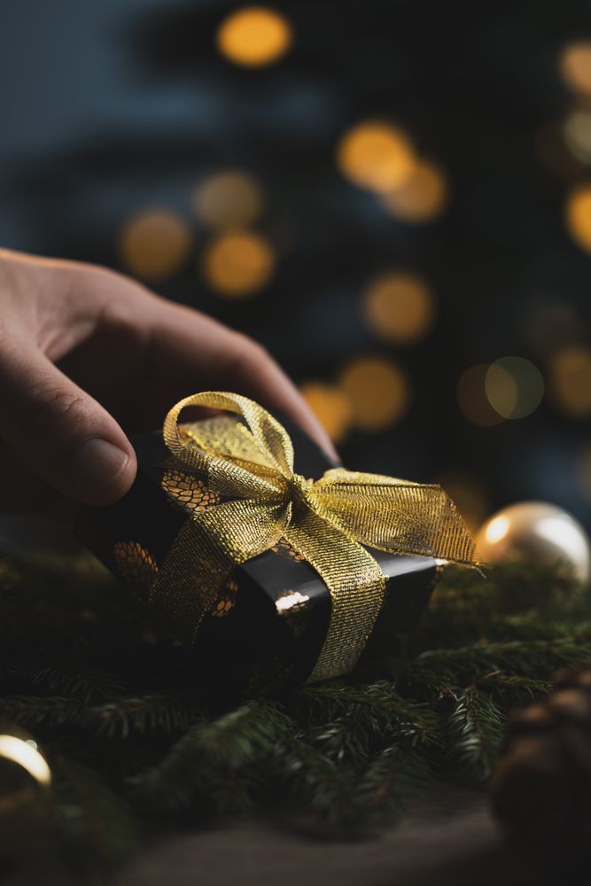 Man holding Christmas gift in hands