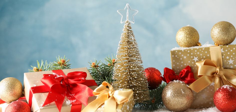 Presents and Christmas tree on decorated background, space for text