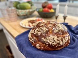 Challah, apples, honey, and candles for festive Rosh Hashanah holiday family meal