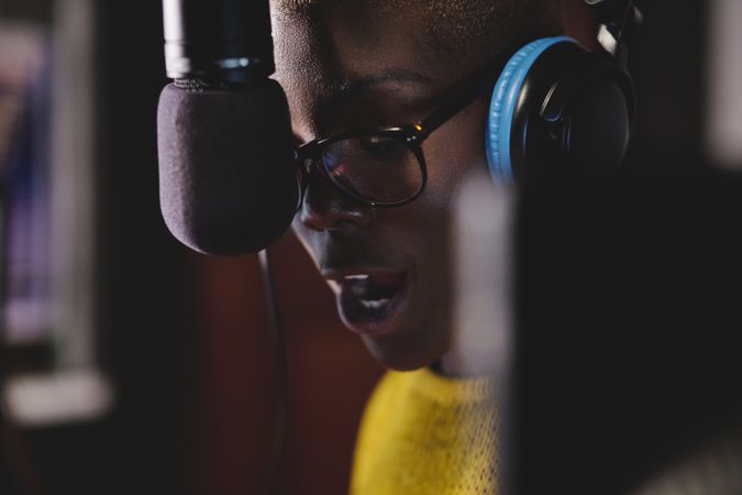 Pensive Black woman recording song