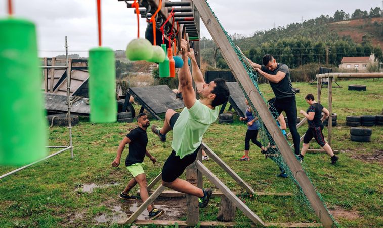Participant obstacle course doing suspension