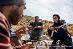 Group of people relaxing and eating lunch on hike 48aBZb