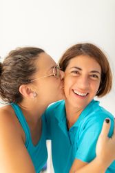 A woman gives a kiss to her physiotherapist friend, after receiving a massage at the physiotherapy clinic