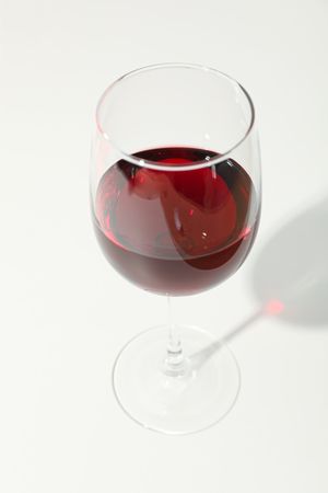 Glass with red wine on blank background, copy space