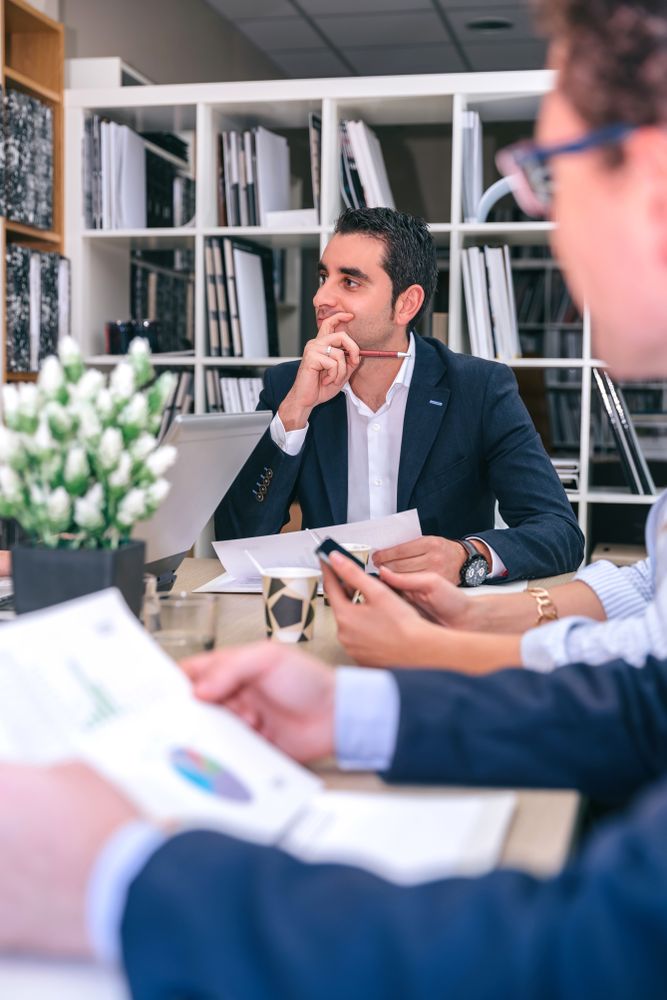 Businessman thinking in a meeting with team