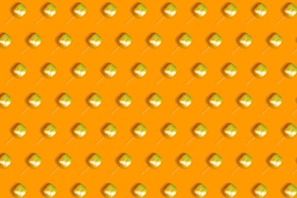 Pattern of floating orange square  balloons with dripping paint on orange background