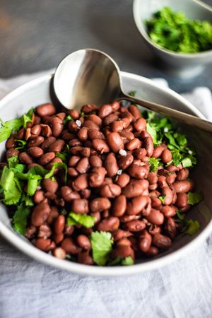 Comforting bowl of Georgian lobio dish atop napkin with cilantro