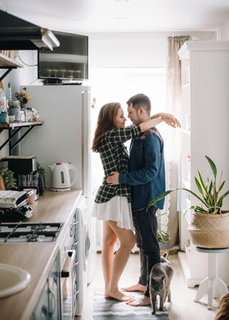 Man and woman about to kiss at home