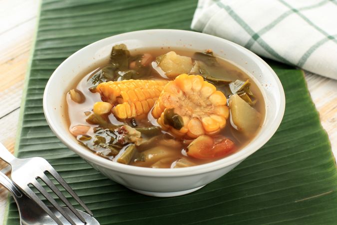 Bowl of Indonesian stew sayur asem on banana leaf