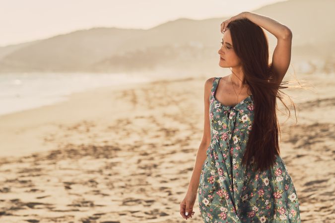 Young woman in the beach at sunset