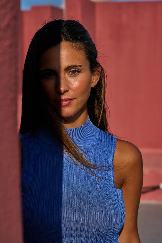 Woman looking at camera in sunlight