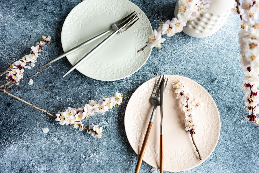 Spring floral concept with apricot blossom branches on two plates
