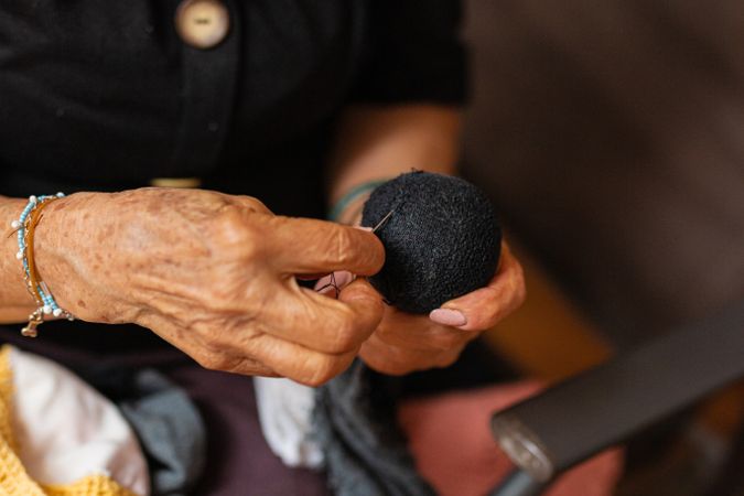Knitting bliss, mature woman creates cozy masterpieces.