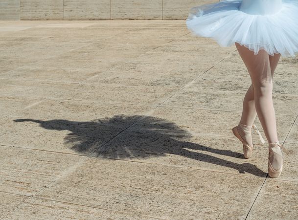 Ballerina standing on tiptoe classical position outside