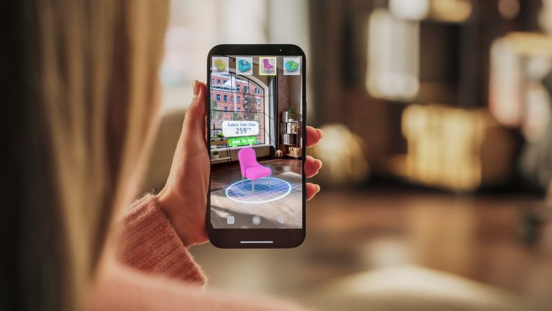 Decorating Apartment: Woman Holding Smartphone, using Augmented Reality Interior Design Software Chooses 3D Furniture for Home.
