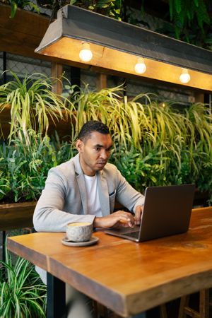 Man working on laptop at cafeteria