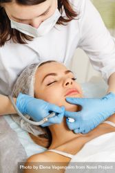 Woman having facial beauty treatment with machine on her jaw, vertical 43YwZ0
