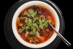 Prepared appetizing frog soup on plate