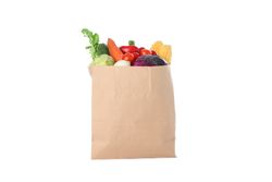 Paper bag with different vegetables isolated on plain background