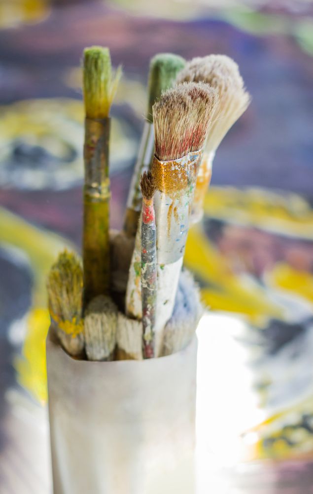 Set of paint brushes on oil painting