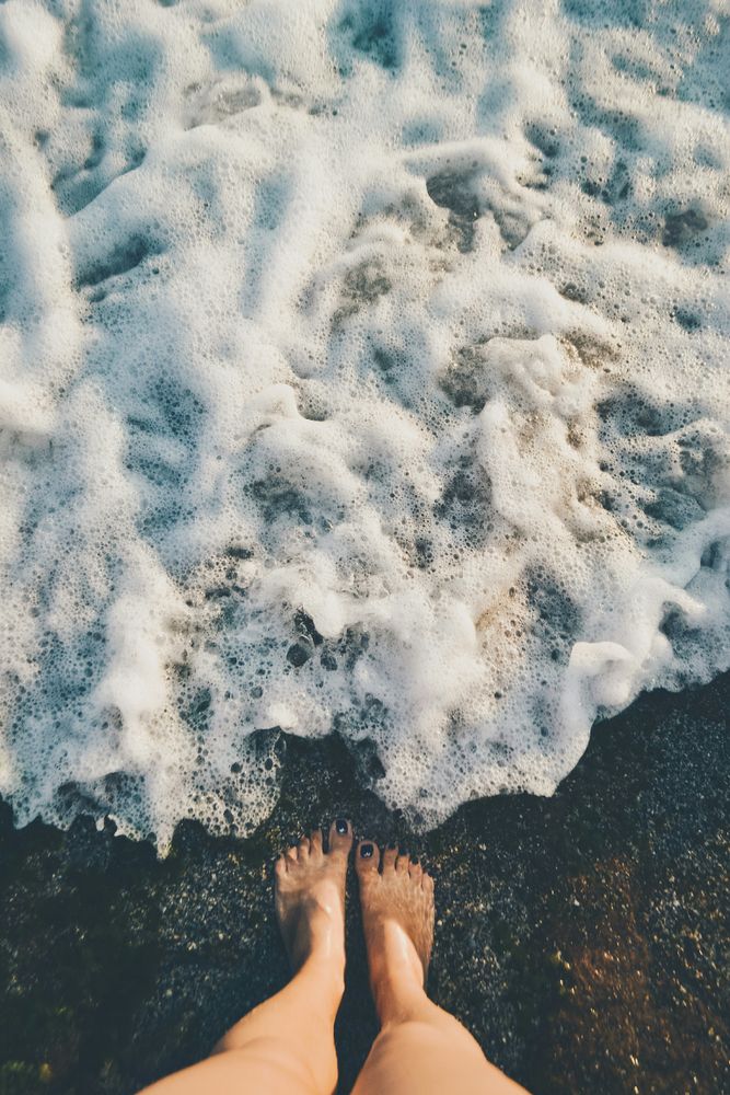 Person standing barefoot on shore