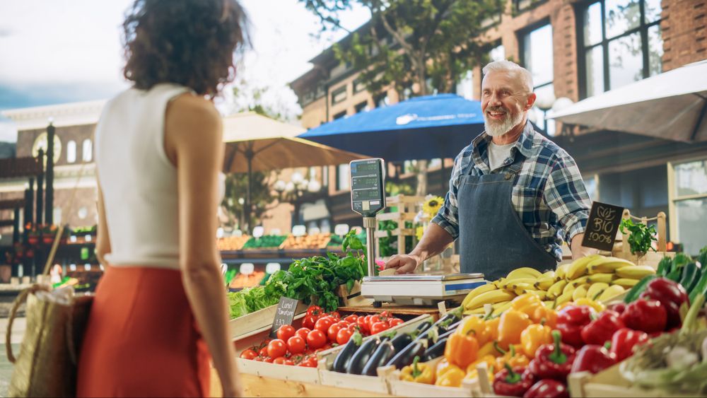 Successful Street Vendors Managing a Small Business Farm Stall at an Outdoors Market