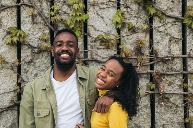 Black couple portrait smiling and holding each other