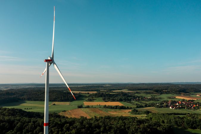 Drone aerial view with a wind turbine near a german village in Baden Wurttemberg region, Germany