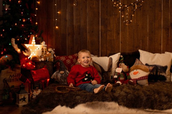 Little boy surrounded by christmas decoration