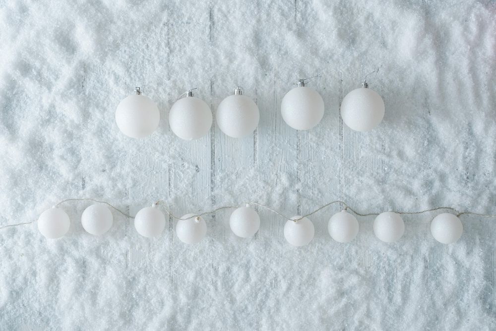 Wooden table background with snow and lights ball decoration