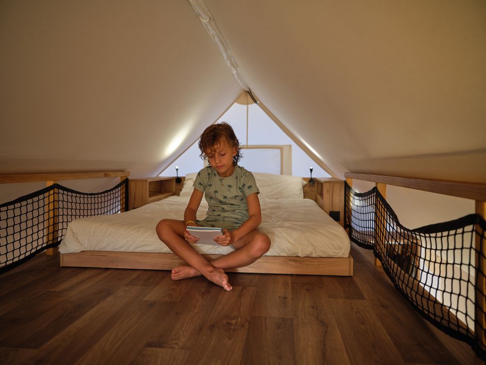 Boy sitting on bed reading